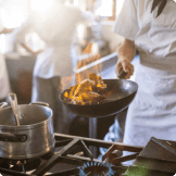 front view of frying pan cooking over stovetop