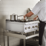 back view of frying pan cooking over stovetop